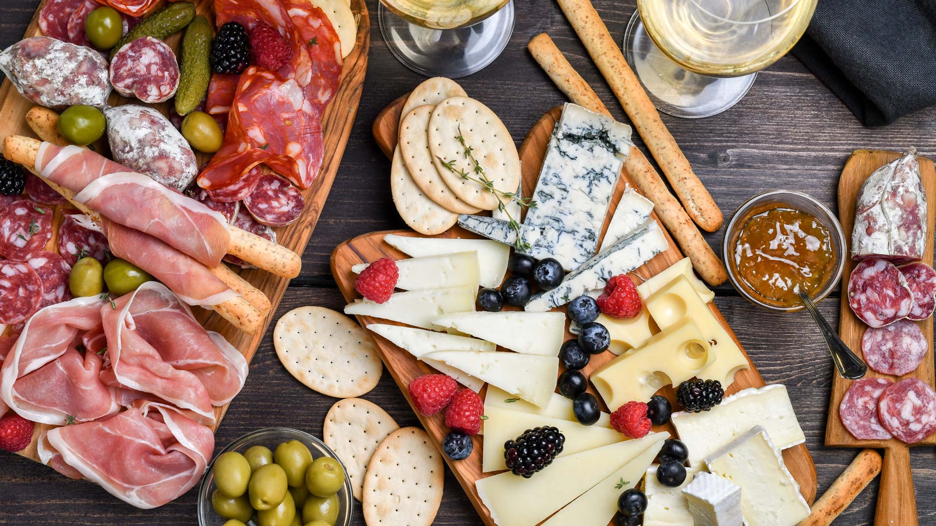 Food antipasto prosciutto ham, salami, olives and grissini bread