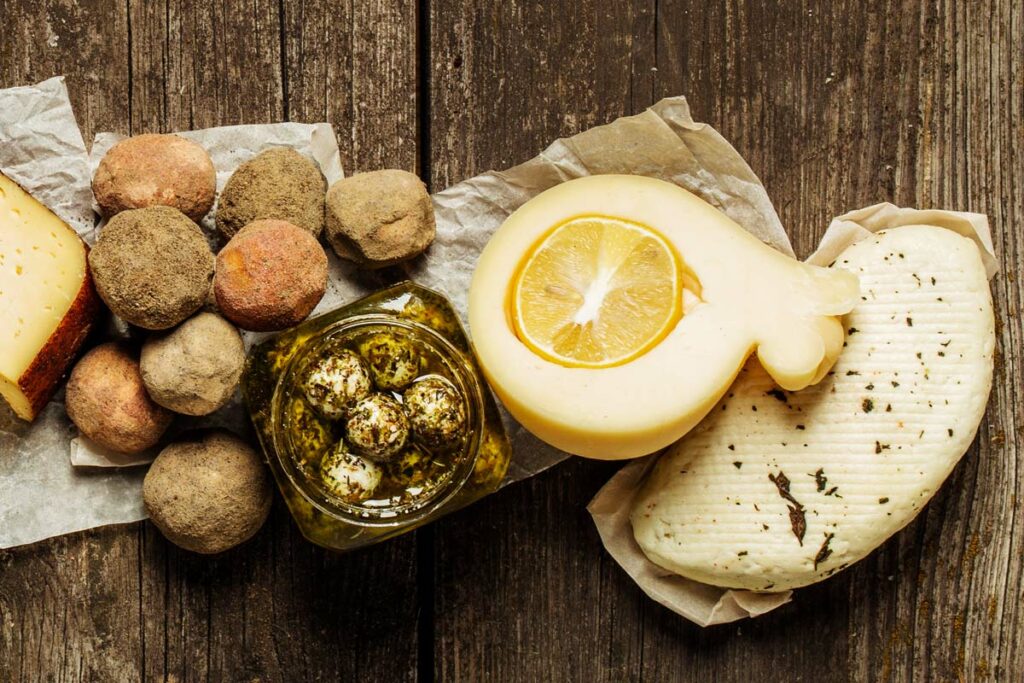 Various types of cheese on wooden table. Top view. Copy space.